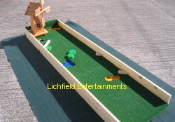 Crazy Golf Course Hire. 'The Open' mobile Crazy Golf hole with features such as bunkers, trees, and a lake to avoid. Also features angled rebound bars and the windmill that every crazy golf course should have!