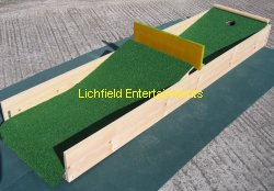 Crazy Golf Course Hire. 'The Ramps' mobile Crazy Golf hole. Hit the ball up the first hill hard enough to get it all the way to the top and roll over but not so hard that it comes back off the bounce back board and rolls back to the start! Once you've completed the first part you then have to putt up a second hill to the hole.